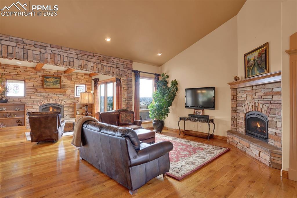4655 Seton Hall Road Colorado Springs, CO 80918 - Photo 8 of 50 a living room with furniture a fireplace and a flat screen tv