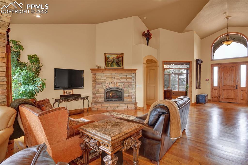 4655 Seton Hall Road Colorado Springs, CO 80918 - Photo 9 of 50 a living room with furniture a fireplace and a flat screen tv