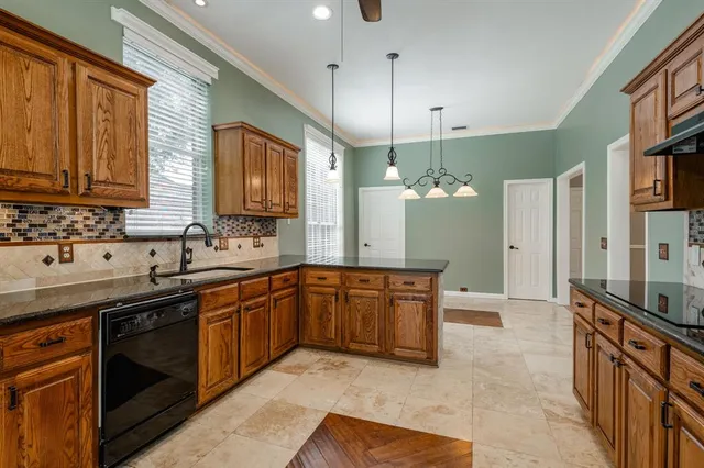 a large kitchen with stainless steel appliances granite countertop a sink a stove and a refrigerator