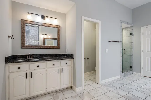 a bathroom with a double vanity sink and mirror