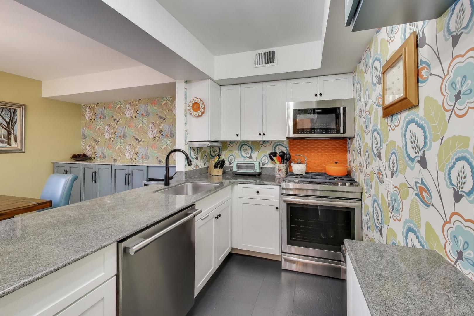 2235 North Lakewood Avenue, Unit FN Chicago, IL 60614 - Photo 19 of 41 a kitchen with stainless steel appliances granite countertop a stove a sink and a microwave