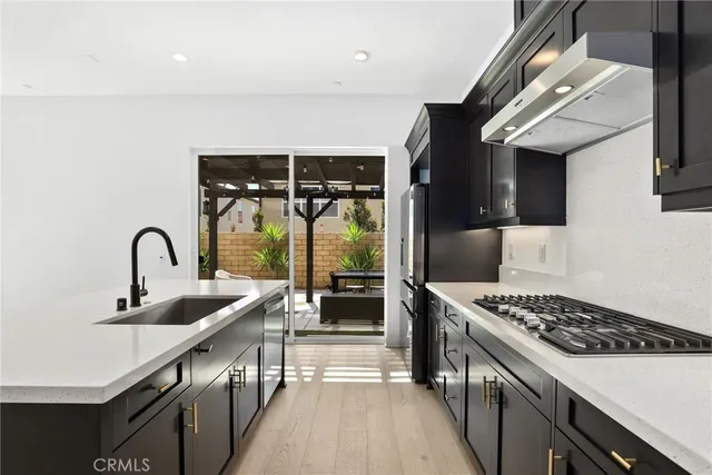 a kitchen with stainless steel appliances a sink stove and cabinets