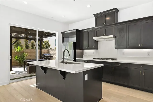 a kitchen with granite countertop a sink and a stove
