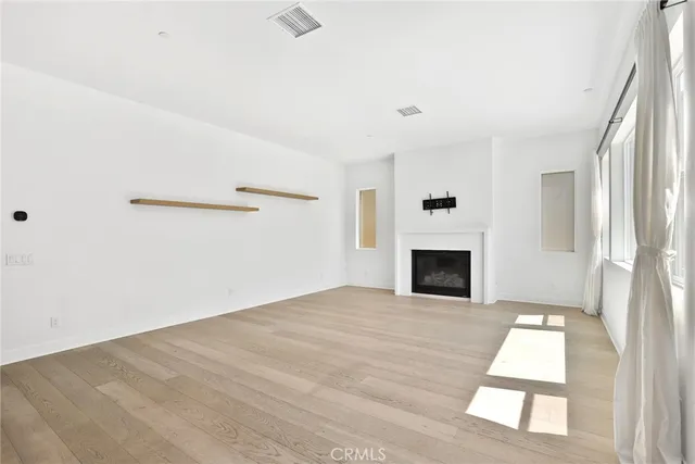 a view of a livingroom with a fireplace and window