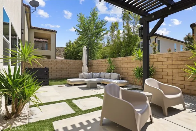 a view of a patio with a table chairs and a backyard