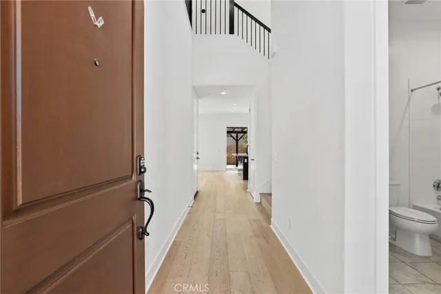 a view of a hallway with wooden floor and staircase