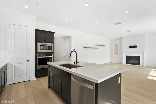 a kitchen with a sink and a refrigerator
