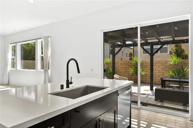 a kitchen with a sink and a large window