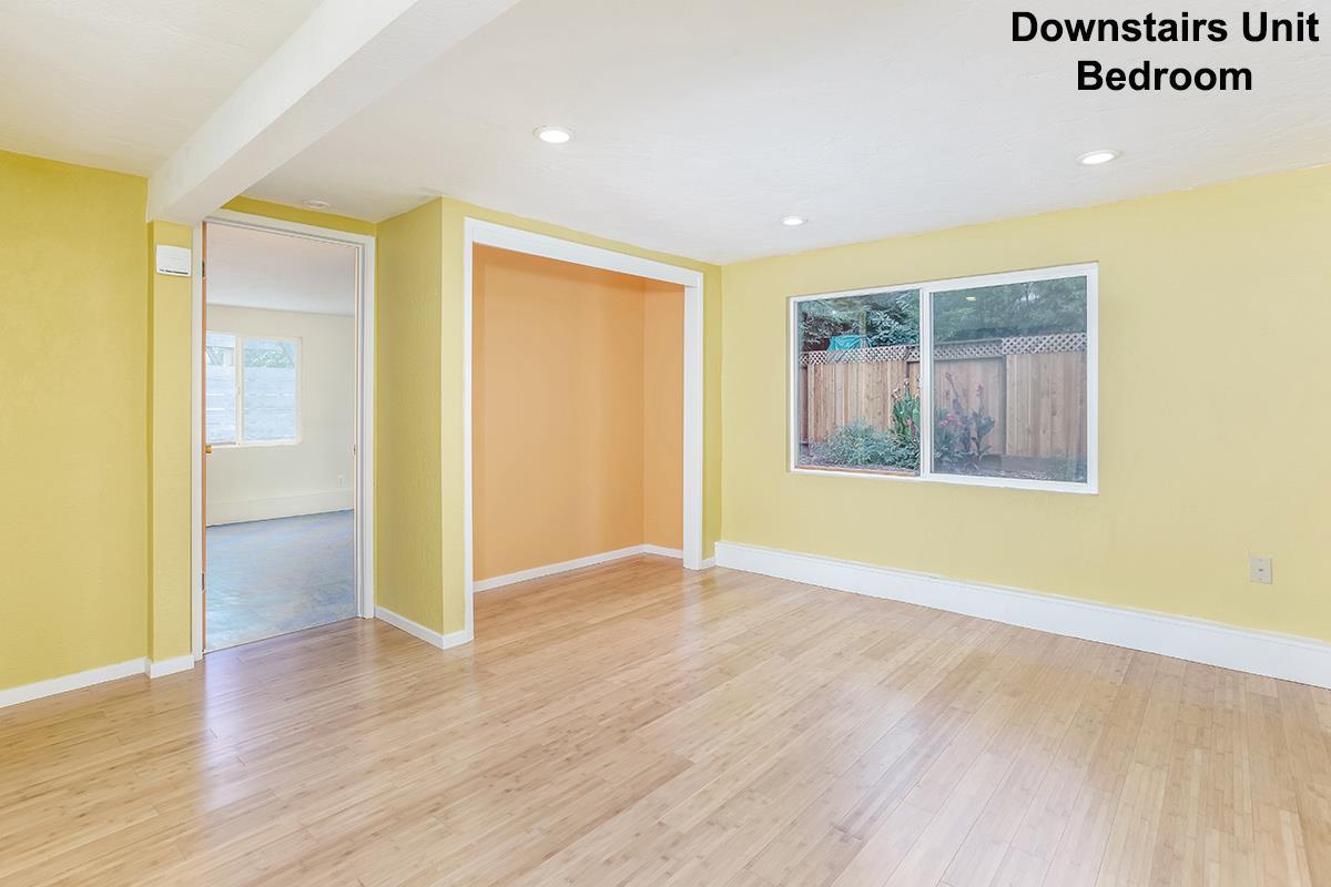 631 Riverside Avenue Santa Cruz, CA 95060 - Photo 13 of 25 an empty room with wooden floor and windows