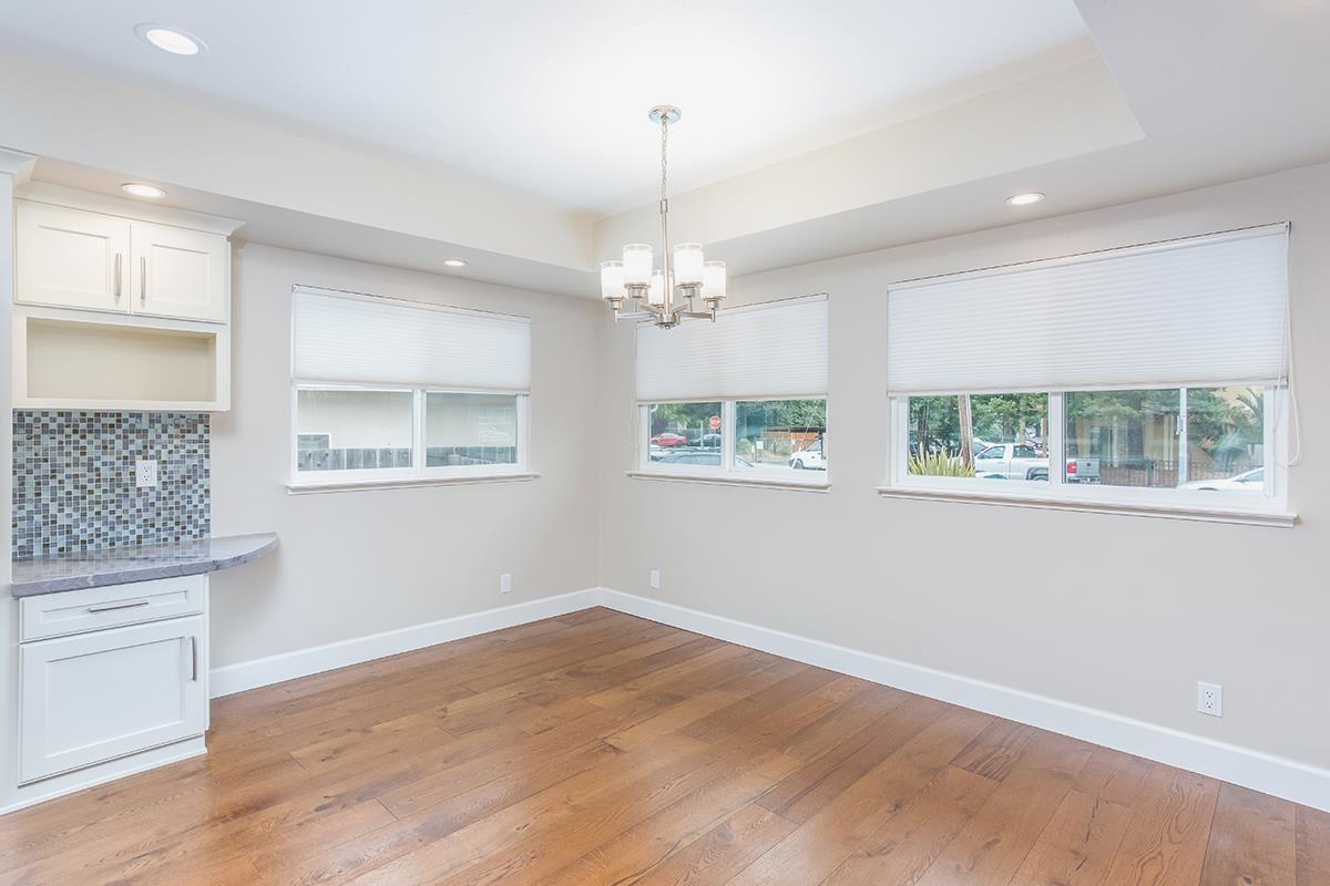 631 Riverside Avenue Santa Cruz, CA 95060 - Photo 5 of 25 a view of an empty room with wooden floor and a window