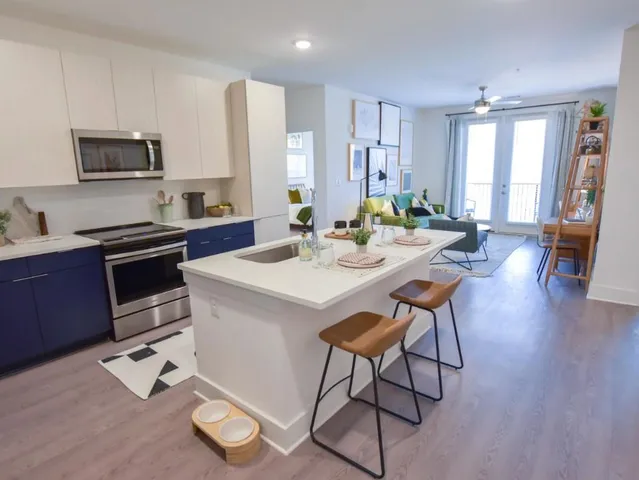 a kitchen with a dining table cabinets and appliances