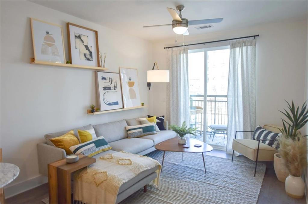 4255 Suwanee Buford Dam Road, Unit 5005202 Suwanee, GA 30024 - Photo 8 of 22 a living room with furniture and wooden floor
