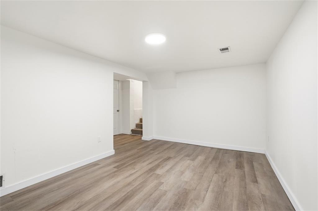 2446 Willowbrook Road Pittsburgh, PA 15241 - Photo 27 of 31 a view of an empty room with wooden floor