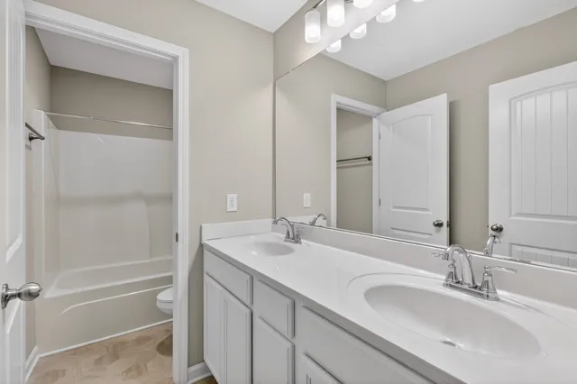 a bathroom with a sink double vanity and a mirror