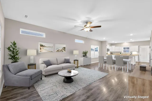 a living room with furniture and view of kitchen