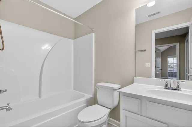 a bathroom with a toilet a sink and a bathtub