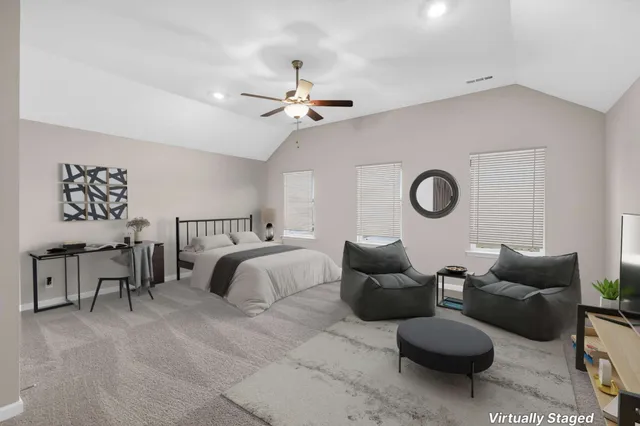 a living room with furniture and a ceiling fan