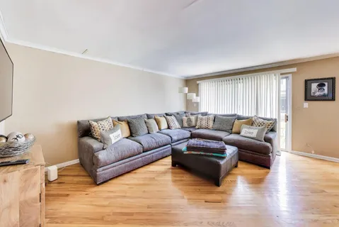 a living room with furniture window and a wooden floor