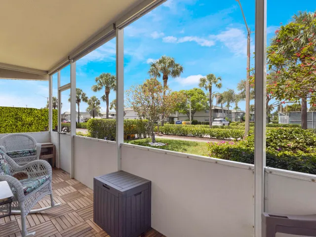 a view of a chair and tables in the balcony