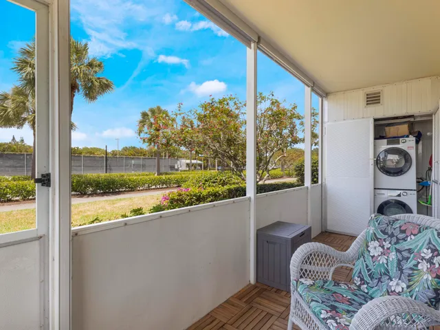 a view of a porch with furniture and a floor to ceiling window