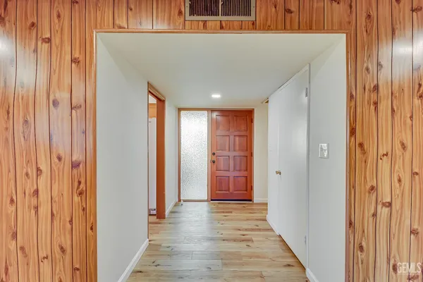 a view of a hallway with wooden floor