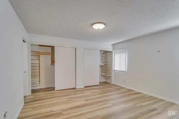 a view of a livingroom with wooden floor and window
