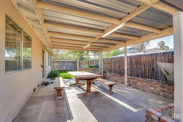 a view of backyard with a patio and a garden