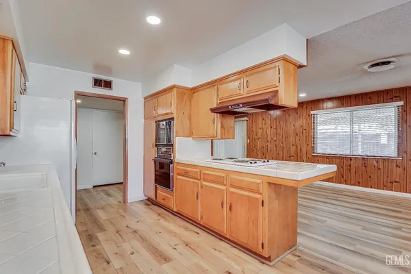 a kitchen with stainless steel appliances granite countertop a stove and a refrigerator