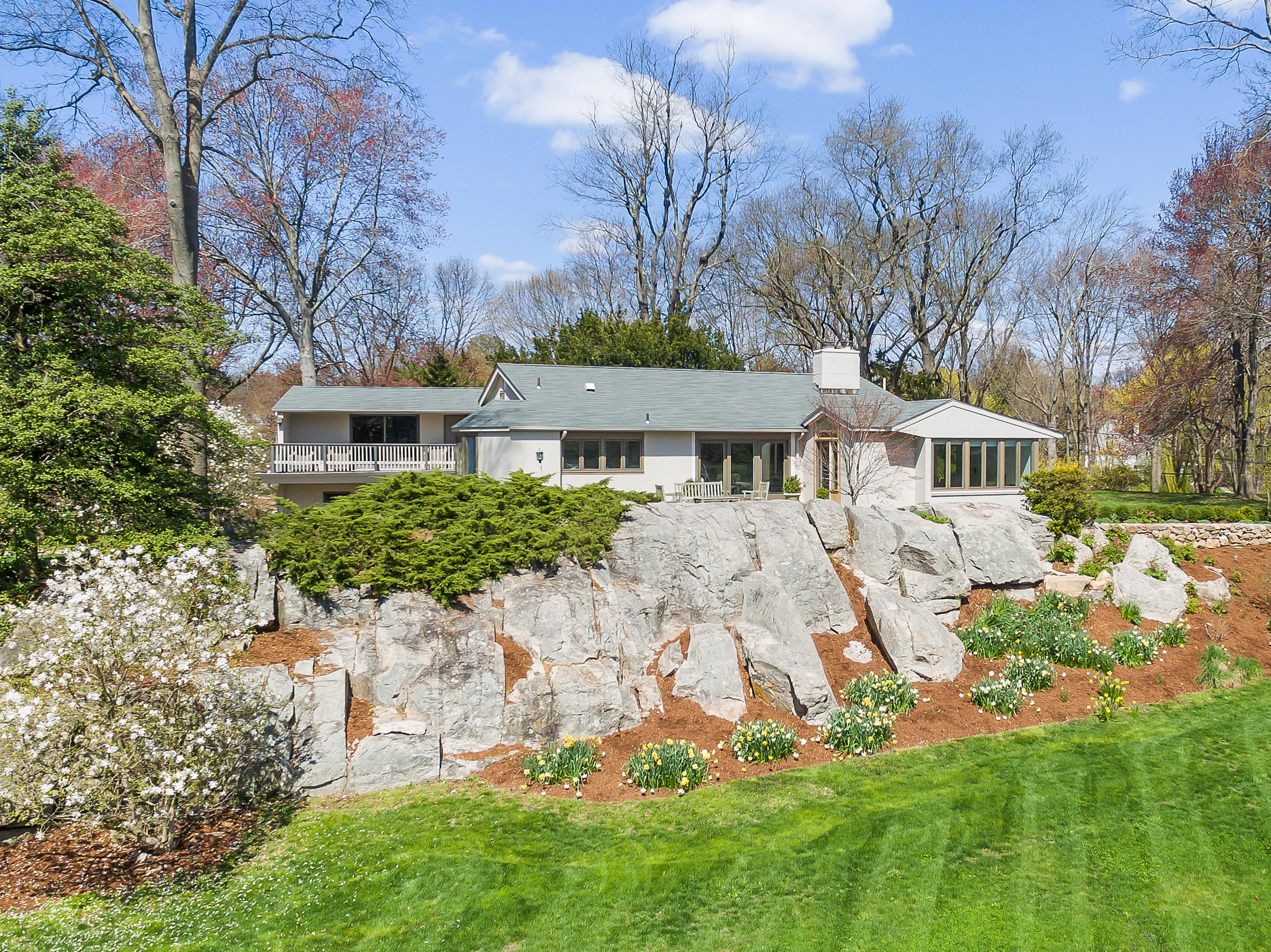 a front view of a house with a garden