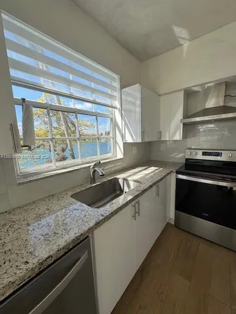 a kitchen that has a sink and a stove
