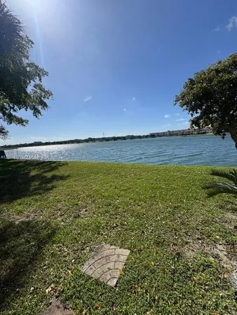 a view of a swimming pool and outdoor seating