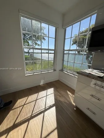 a view of a livingroom with wooden floor and furniture