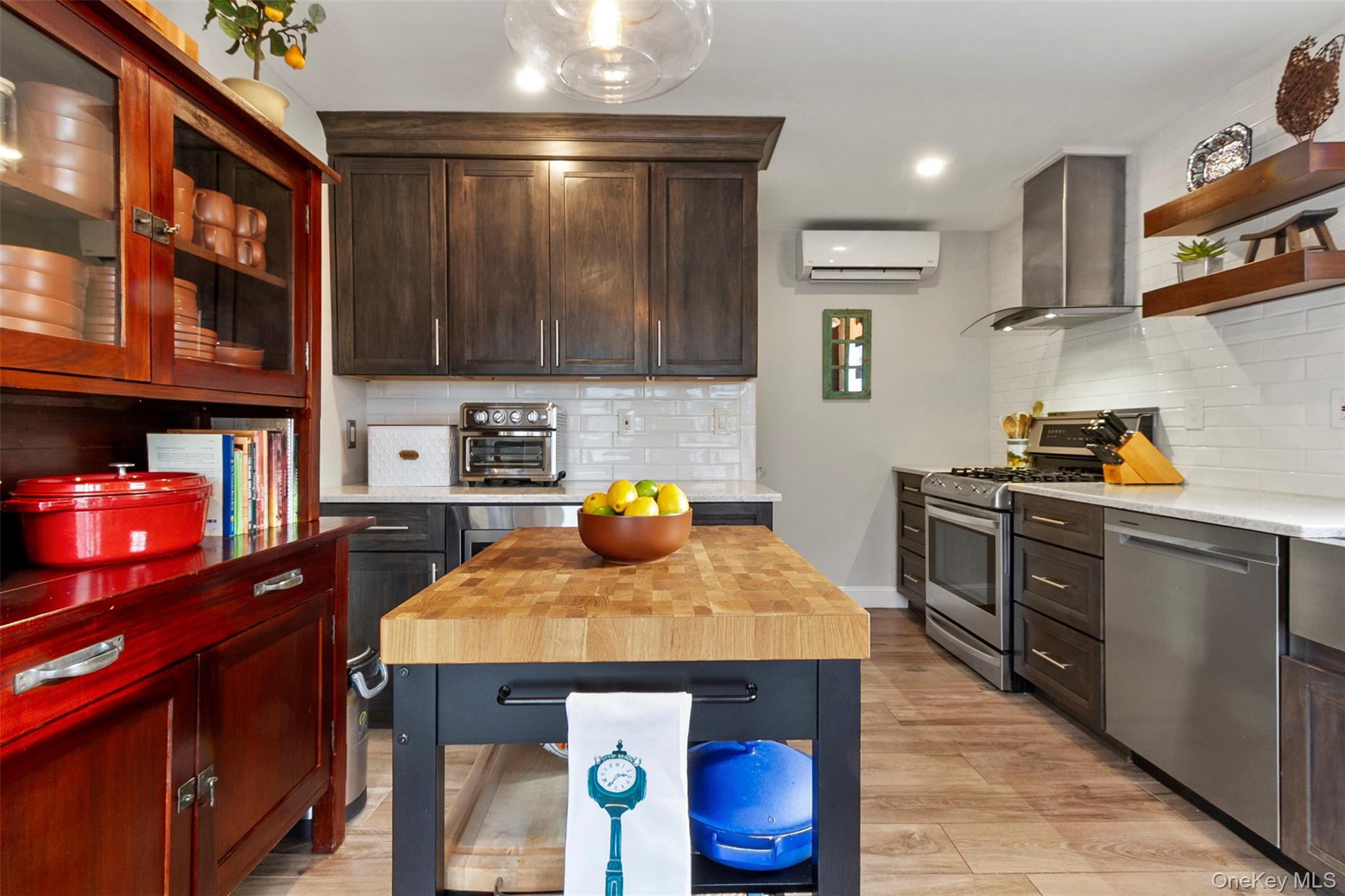 189 Rombout Avenue Beacon, NY 12508 - Photo 13 of 35 a kitchen with stainless steel appliances wooden cabinets and stove top oven