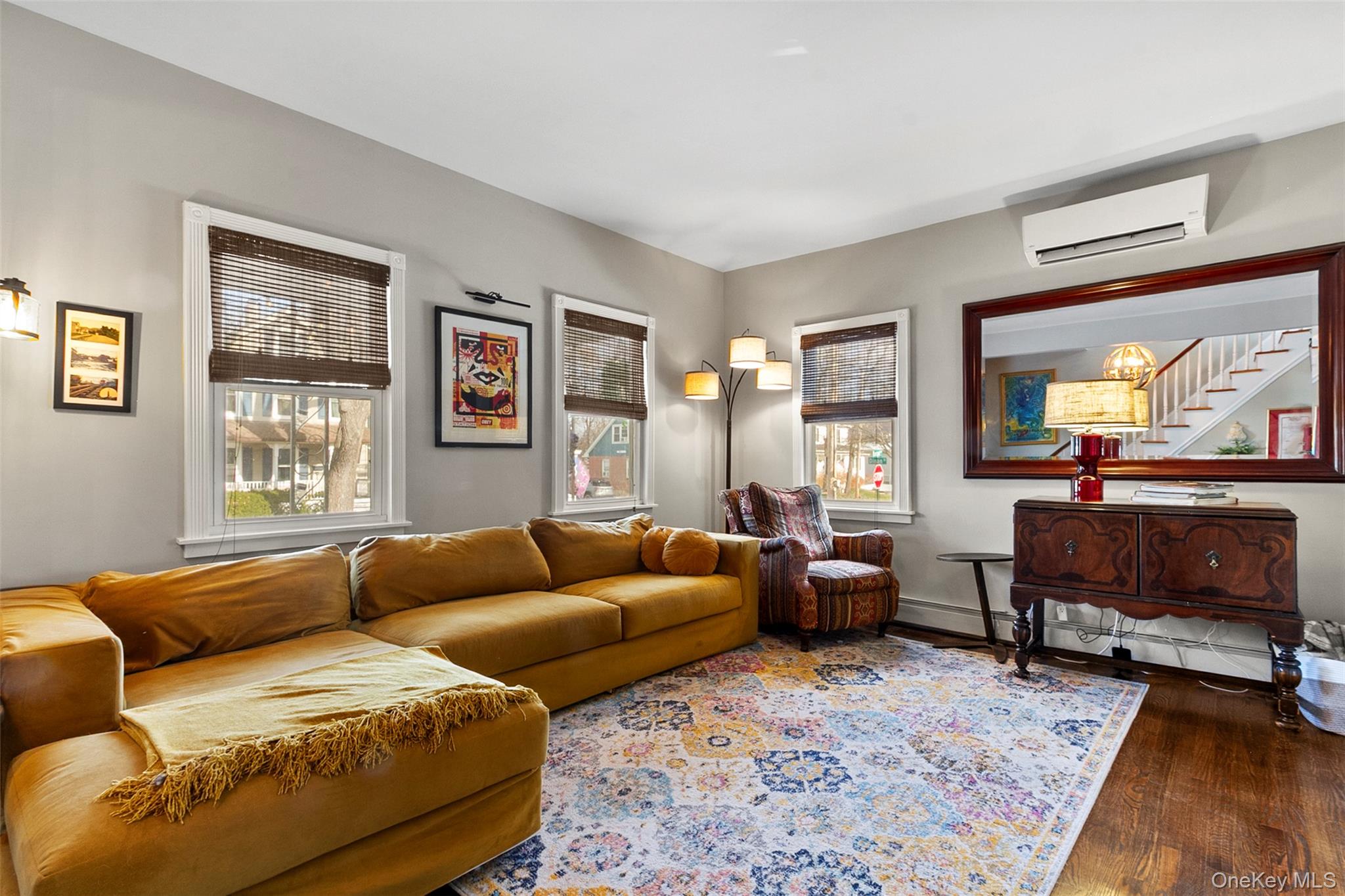 189 Rombout Avenue Beacon, NY 12508 - Photo 7 of 35 a living room with furniture two windows and a flat screen tv