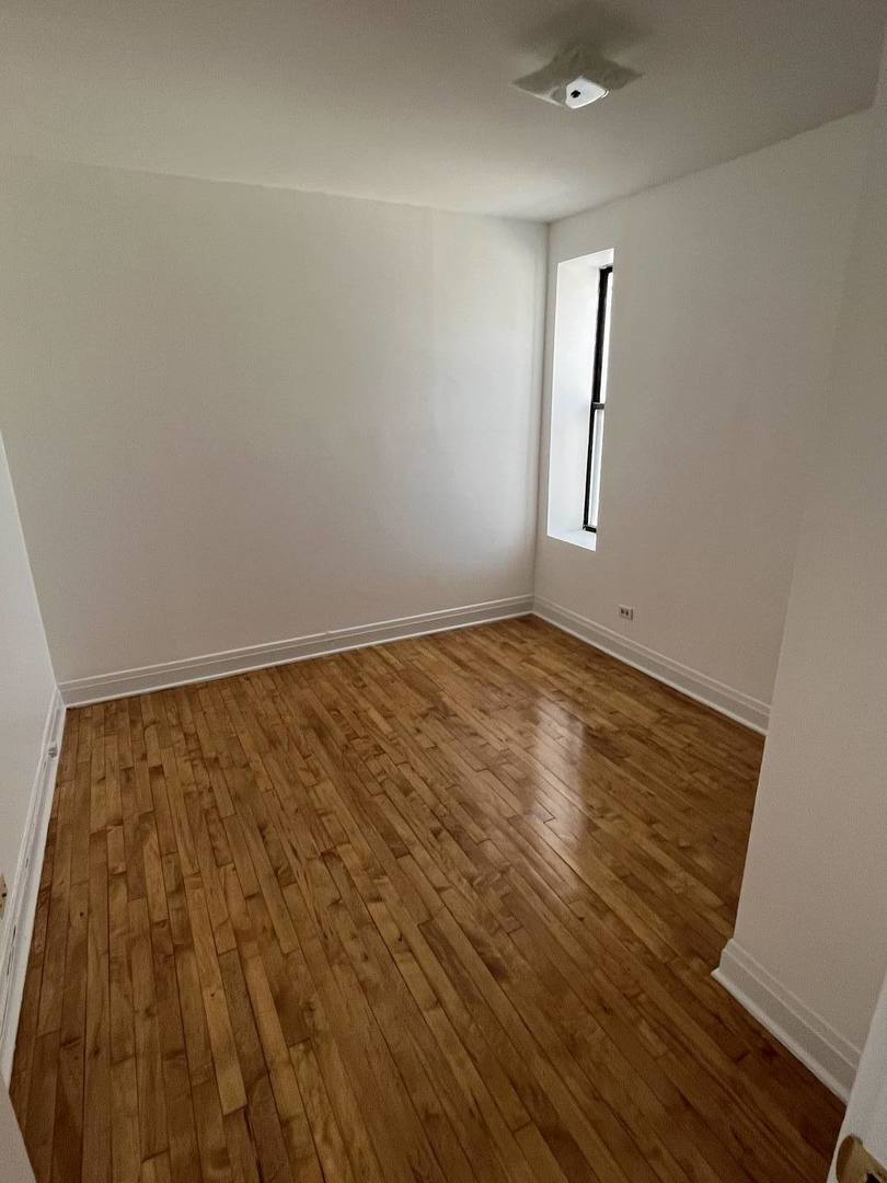 8016 South Halsted Street, Unit 2N Chicago, IL 60620 - Photo 11 of 13 wooden floor in an empty room