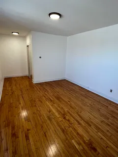 a view of an empty room and wooden floor