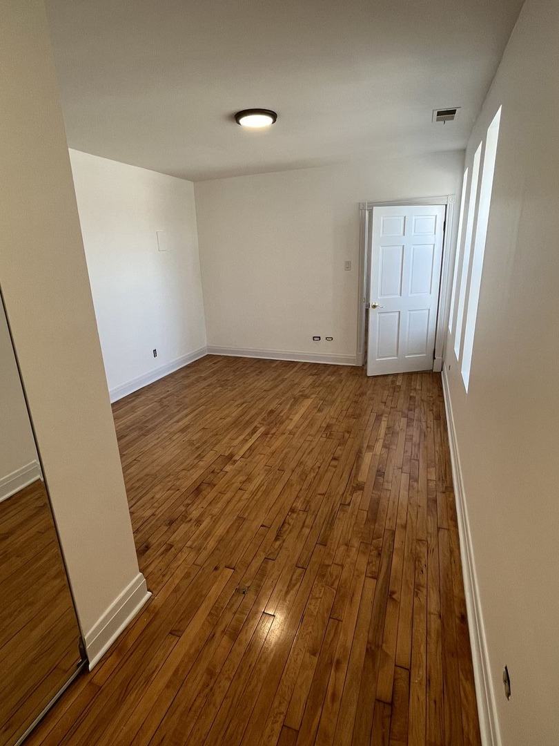 8016 South Halsted Street, Unit 2N Chicago, IL 60620 - Photo 8 of 13 a view of a room with wooden floor