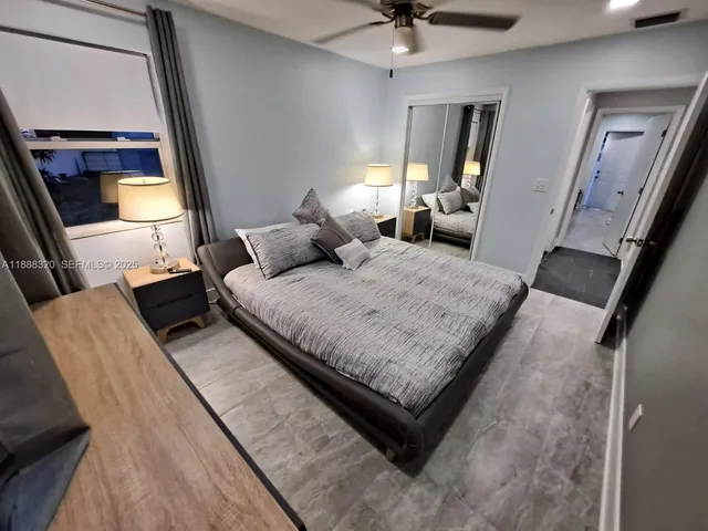 a bedroom with a bed window and a couch