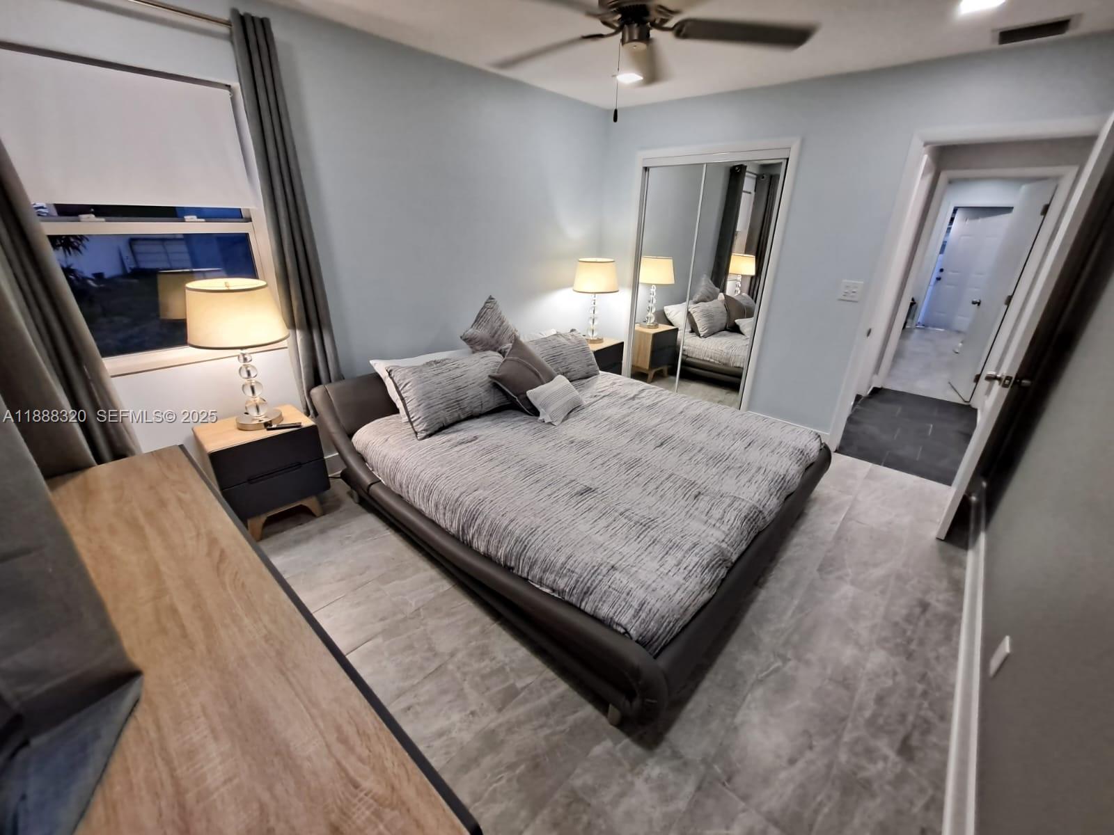 2242 Polk Street, Unit 1 Hollywood, FL 33020 - Photo 11 of 31 a bedroom with a bed window and a couch