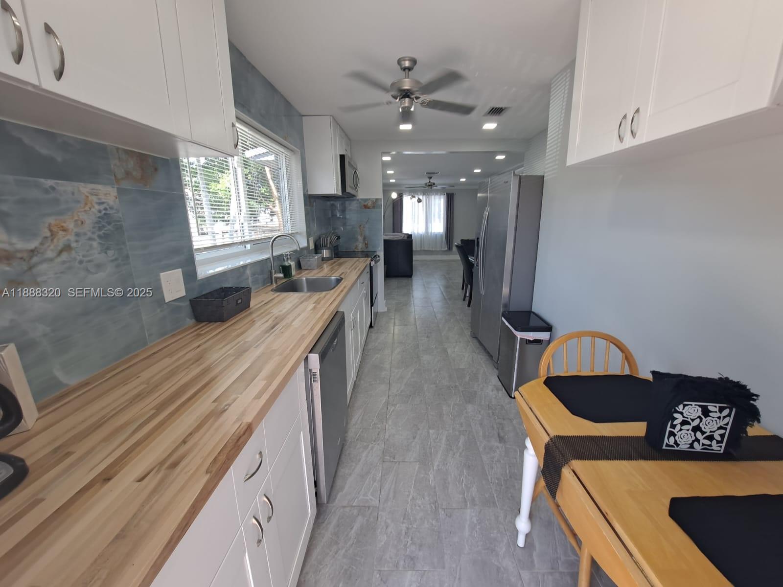 2242 Polk Street, Unit 1 Hollywood, FL 33020 - Photo 14 of 31 a living room with furniture and window