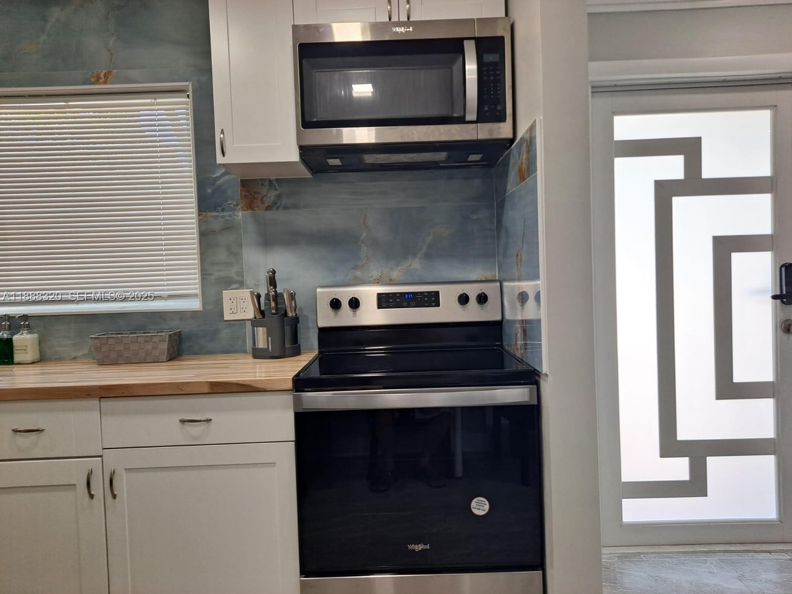2242 Polk Street, Unit 1 Hollywood, FL 33020 - Photo 15 of 31 a kitchen with a stove and a microwave