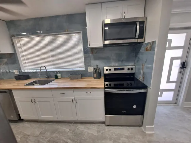 a kitchen with a stove and a sink