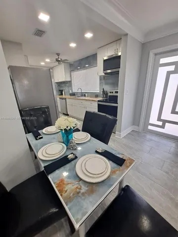 a open dining room with furniture and kitchen view