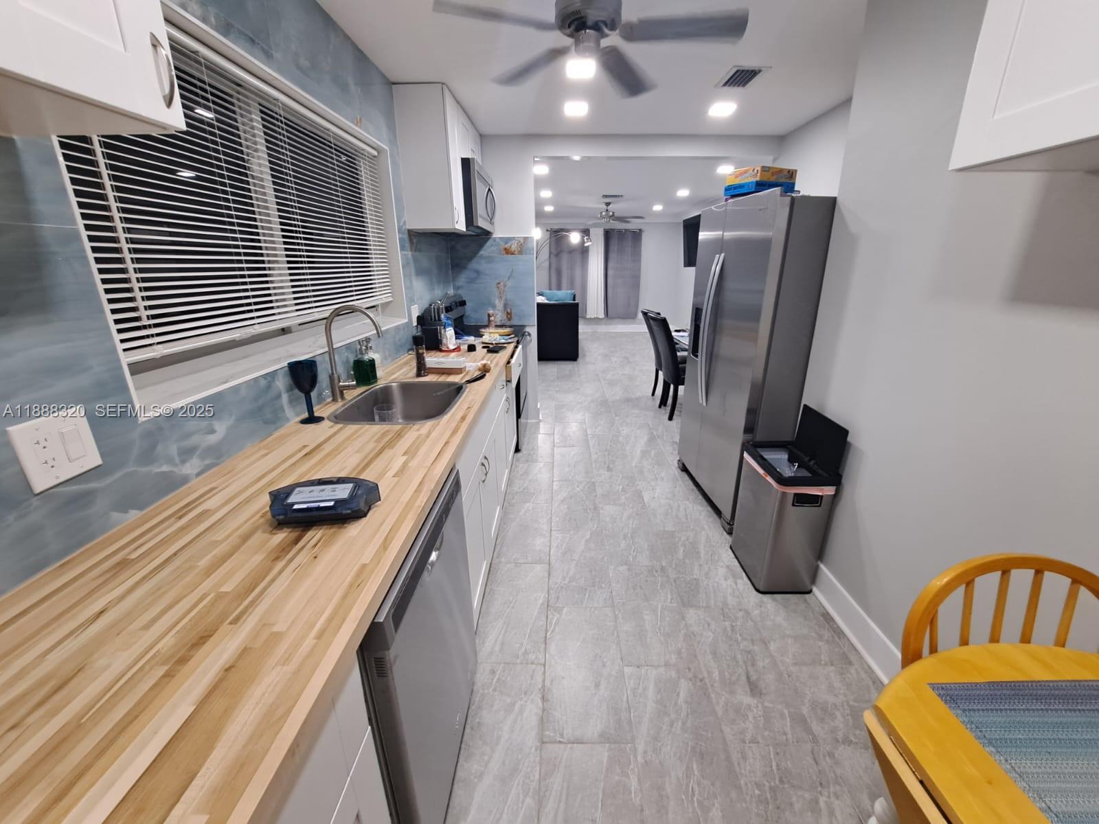 2242 Polk Street, Unit 1 Hollywood, FL 33020 - Photo 25 of 31 a living room with furniture and a wooden floor