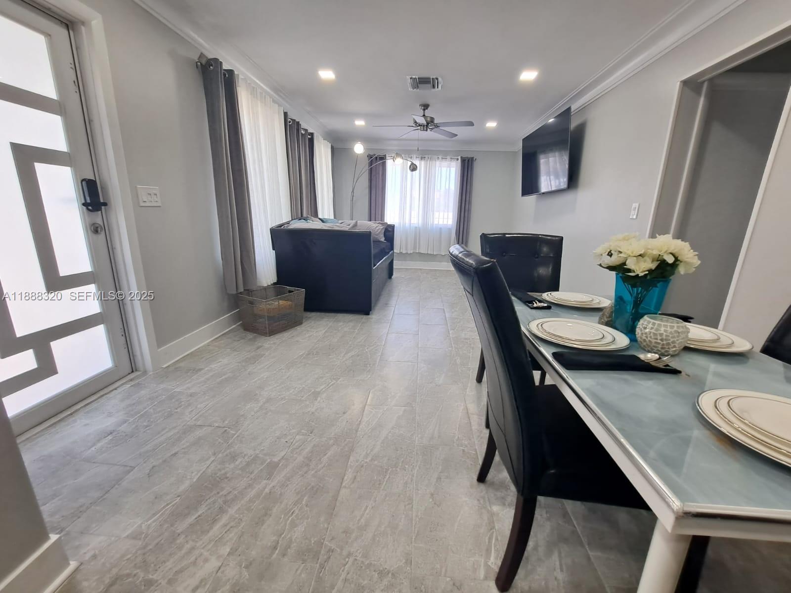 2242 Polk Street, Unit 1 Hollywood, FL 33020 - Photo 27 of 31 a living room with furniture and wooden floor