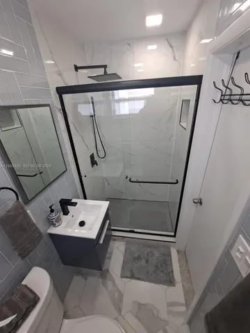 a bathroom with a tub sink and mirror