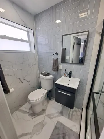 a bathroom with a sink toilet and mirror