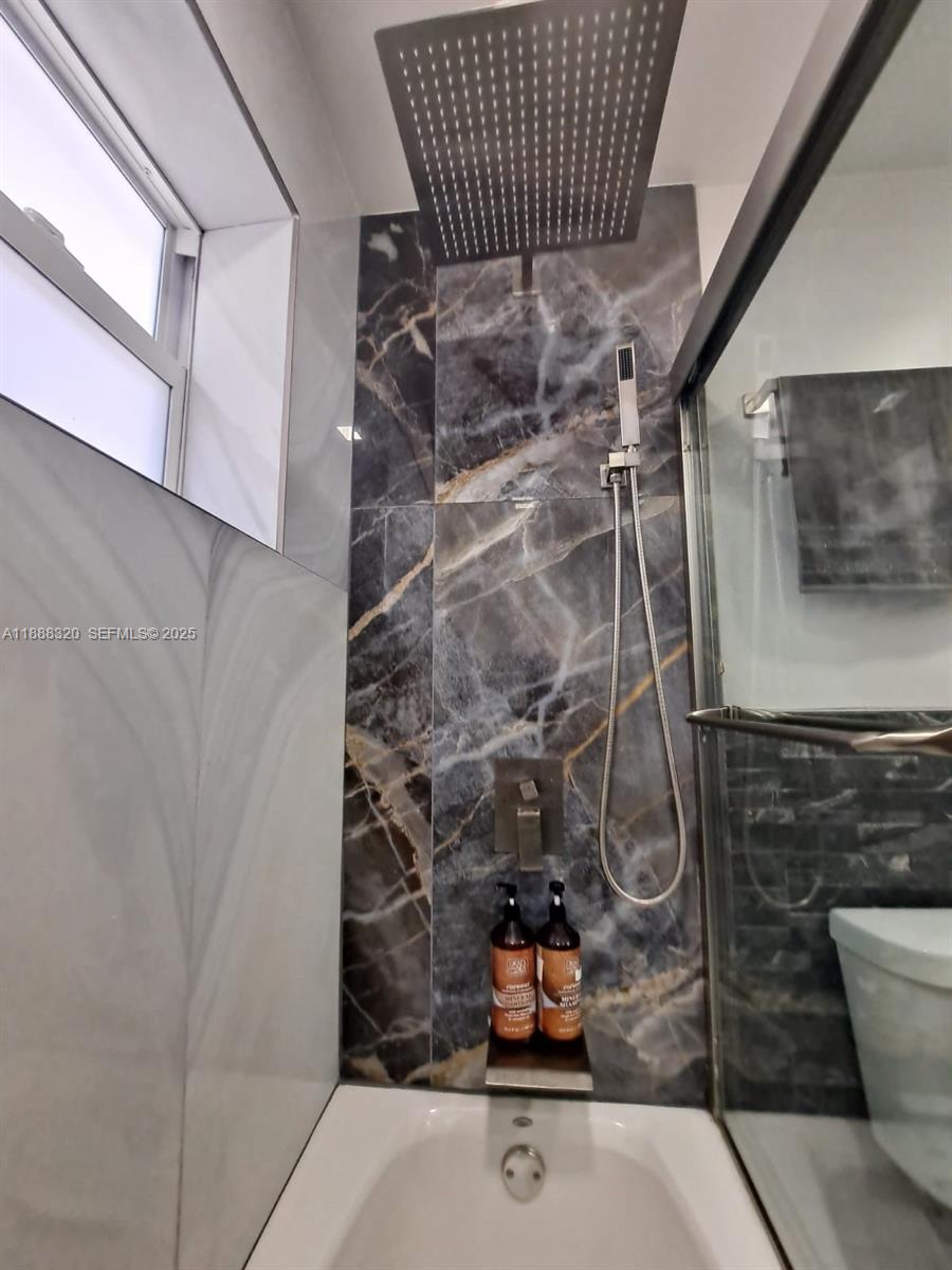 2242 Polk Street, Unit 1 Hollywood, FL 33020 - Photo 9 of 31 a bathroom with a sink and a shower