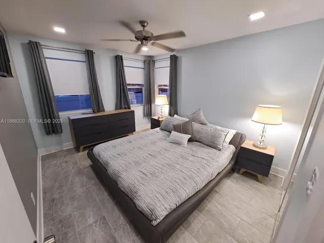 a bed room with a bed window and a mirror