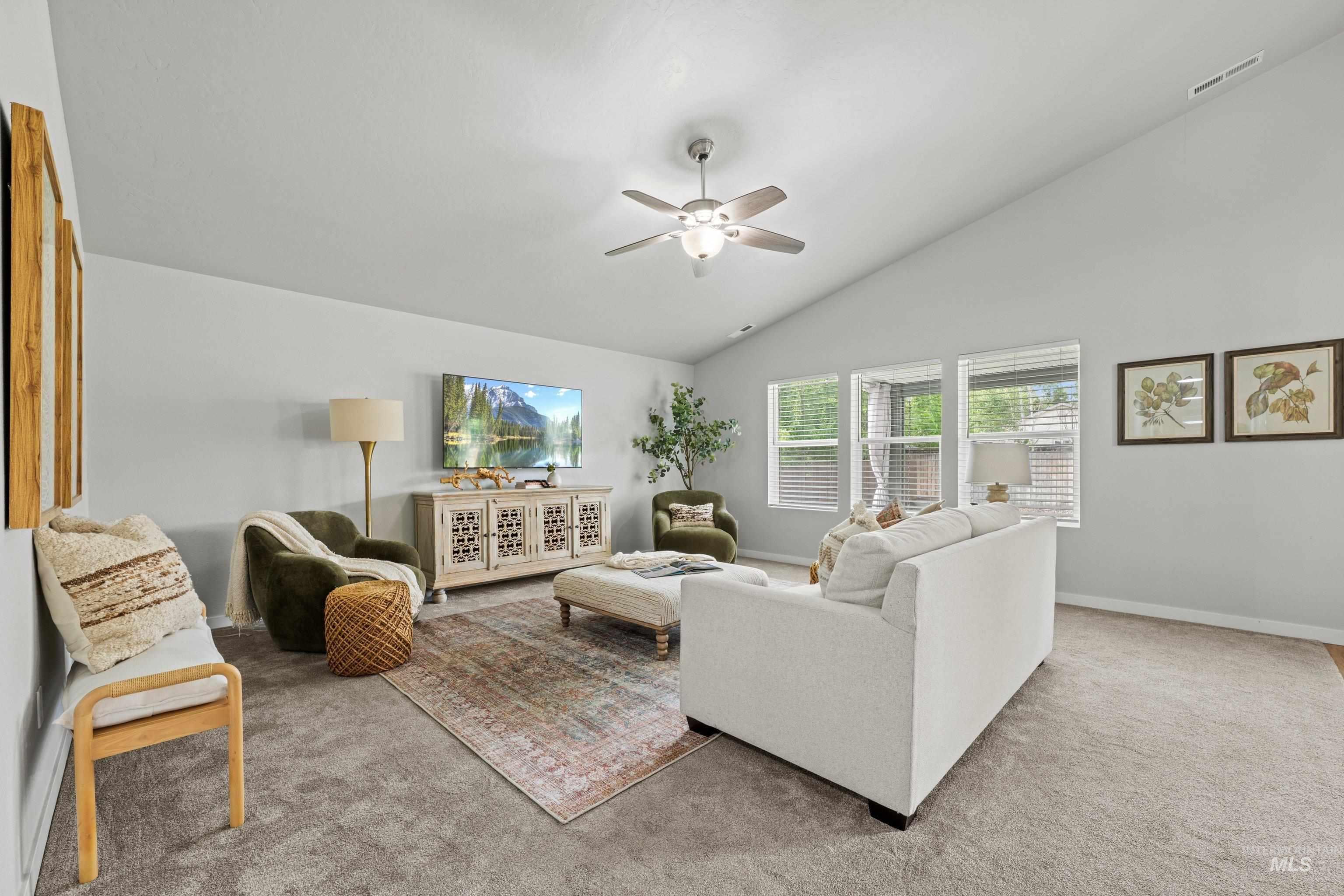12744 West Fig Street Boise, ID 83713 - Photo 6 of 34 Spacious living area featuring a vaulted ceiling and light gray walls